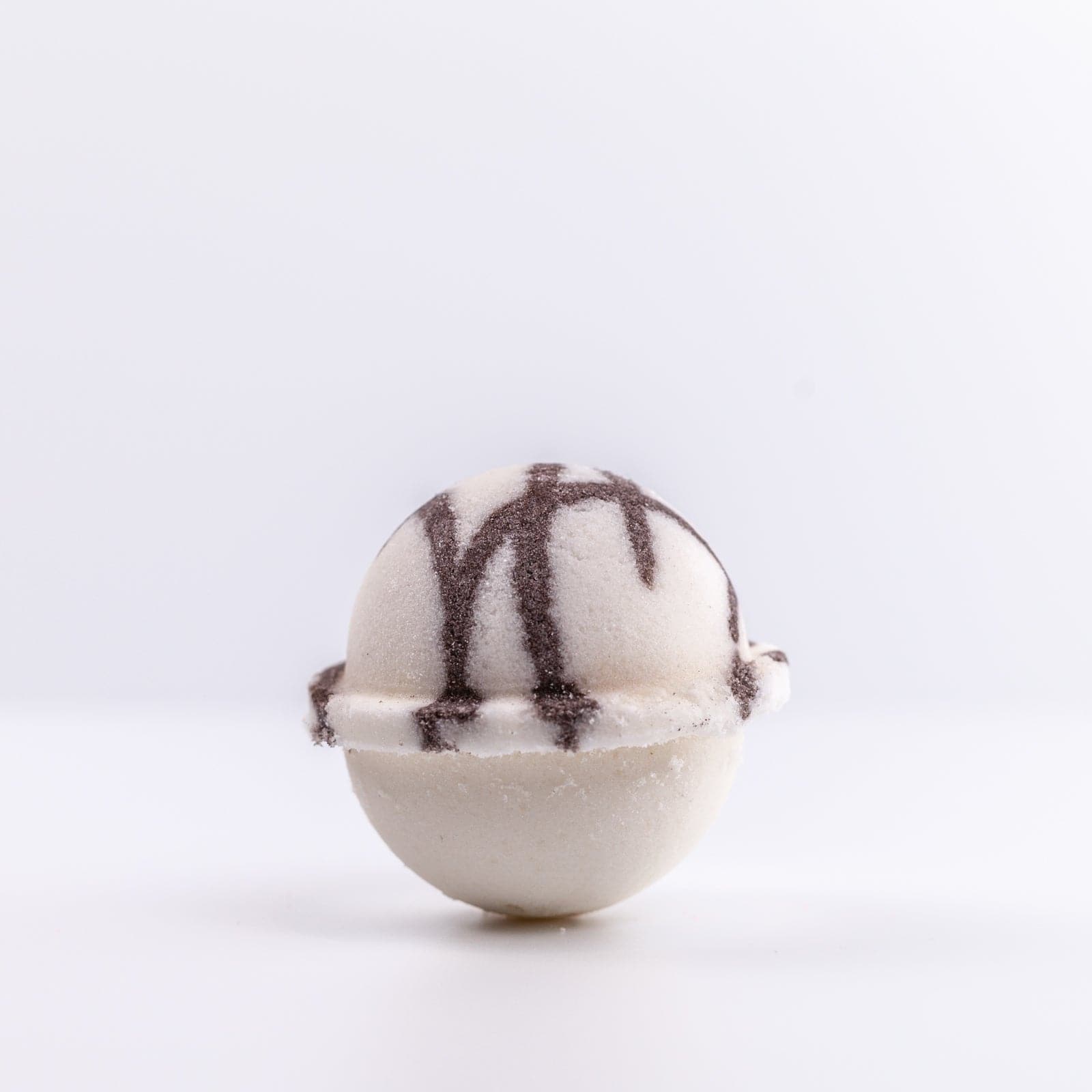 Coconut Bath Bomb with brown and white design against white background
