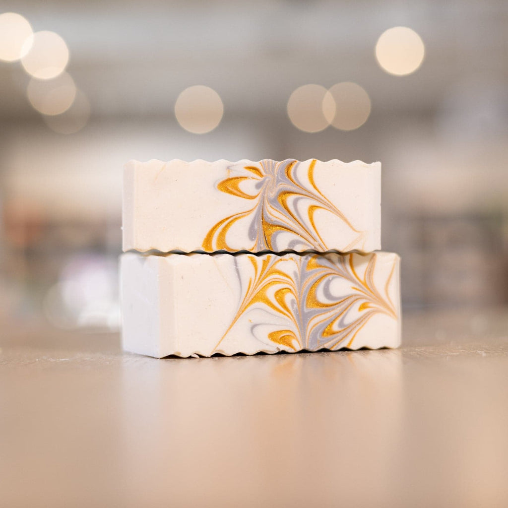 Two Ferocious Beast Soap Bars with silver and gold design stacked on wooden counter