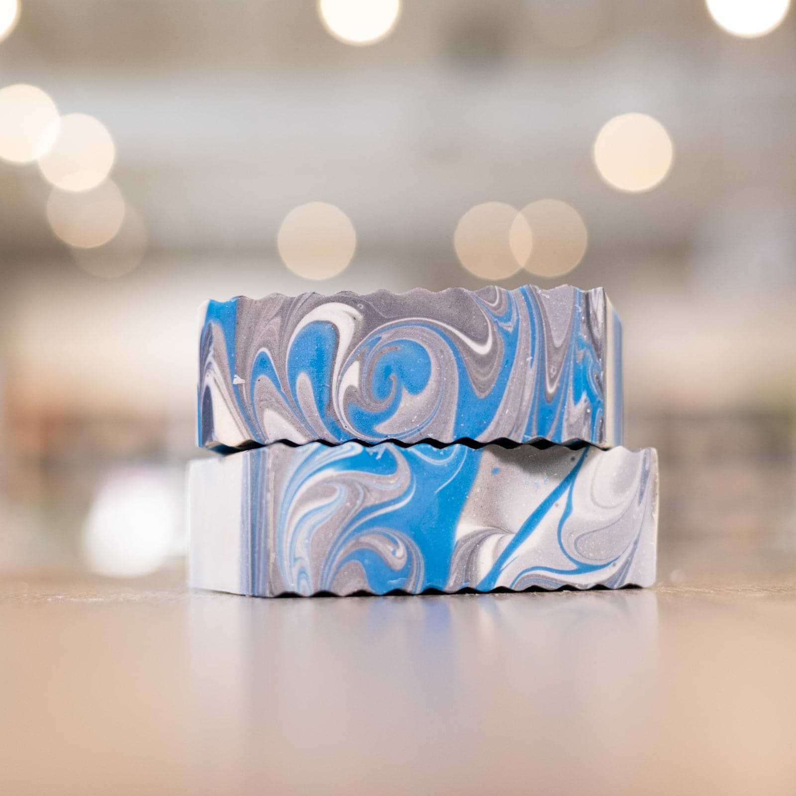 Hey Headache Soap Bars with blue and grey swirls stacked on top of counter