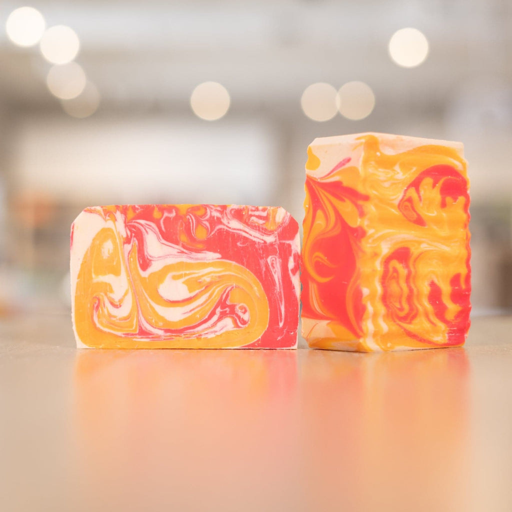 Two Island Nectar Soap Bars with red and orange designs on counter