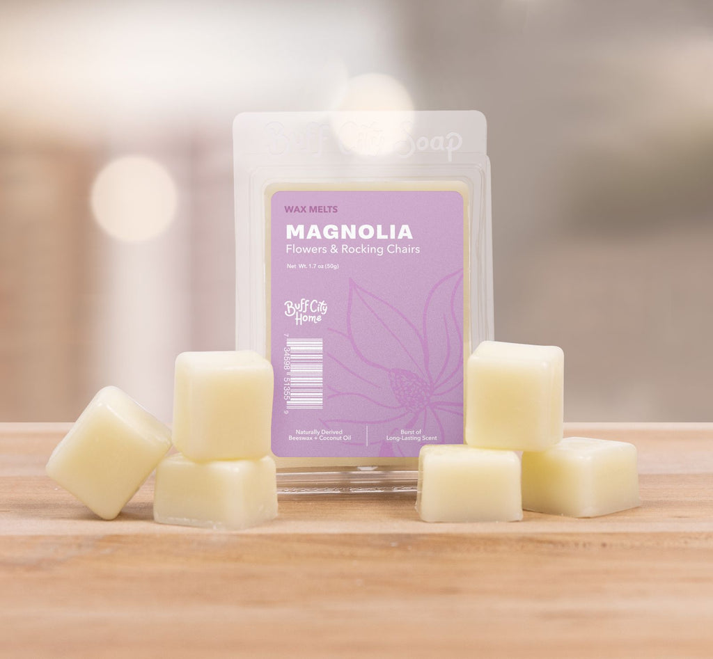 Magnolia Wax Melts staggered in front of container 