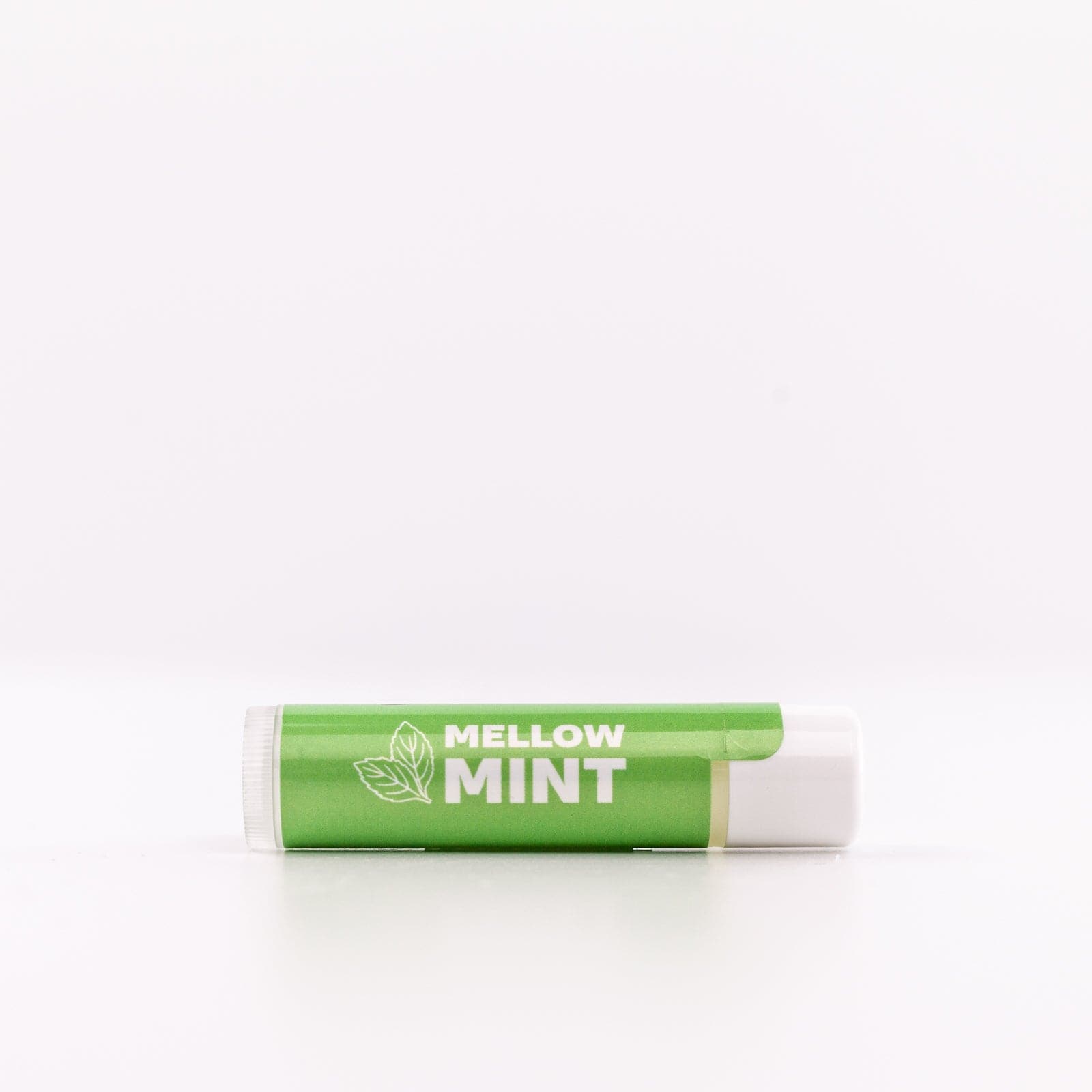 one Mellow Mint Lip Balm placed on it's side