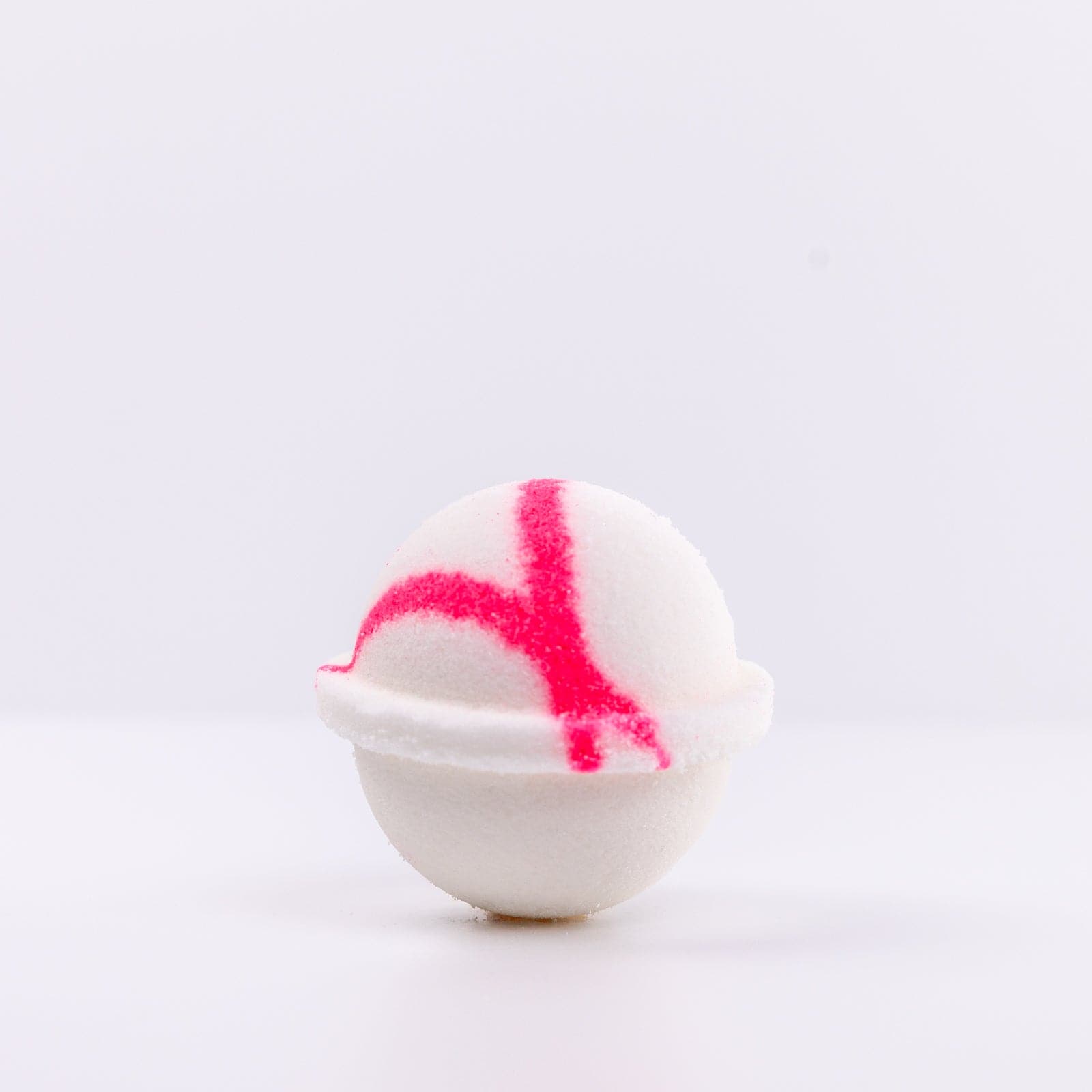 one white Mermaid Bath Bomb with a pink "X" design
