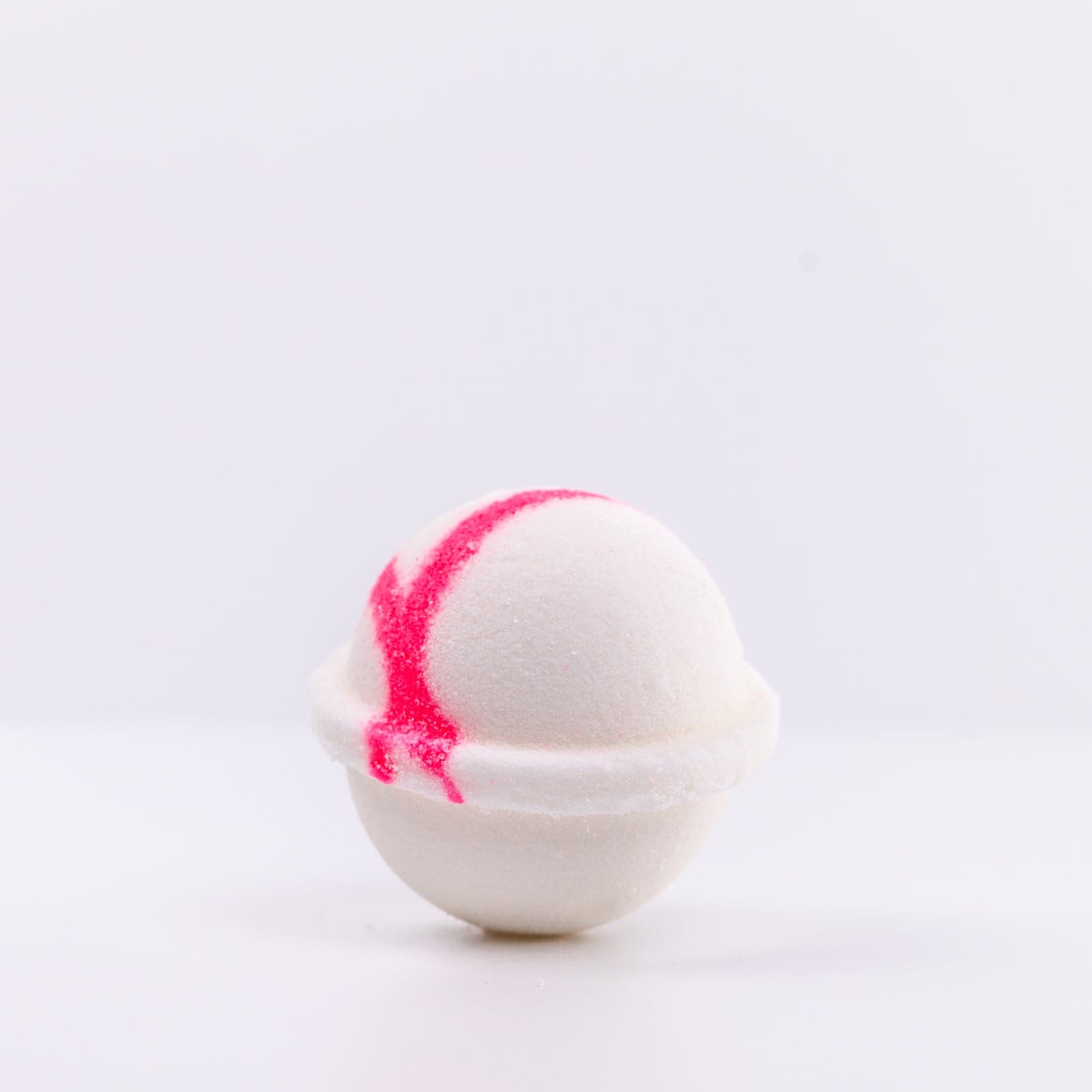 one white Mermaid Bath Bomb with pink "X" design on left side of bath bomb