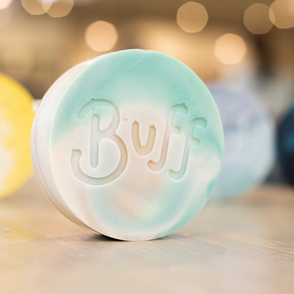 angled right view of teal and white Narcissist Shave Bar with "Buff" engraved in bar