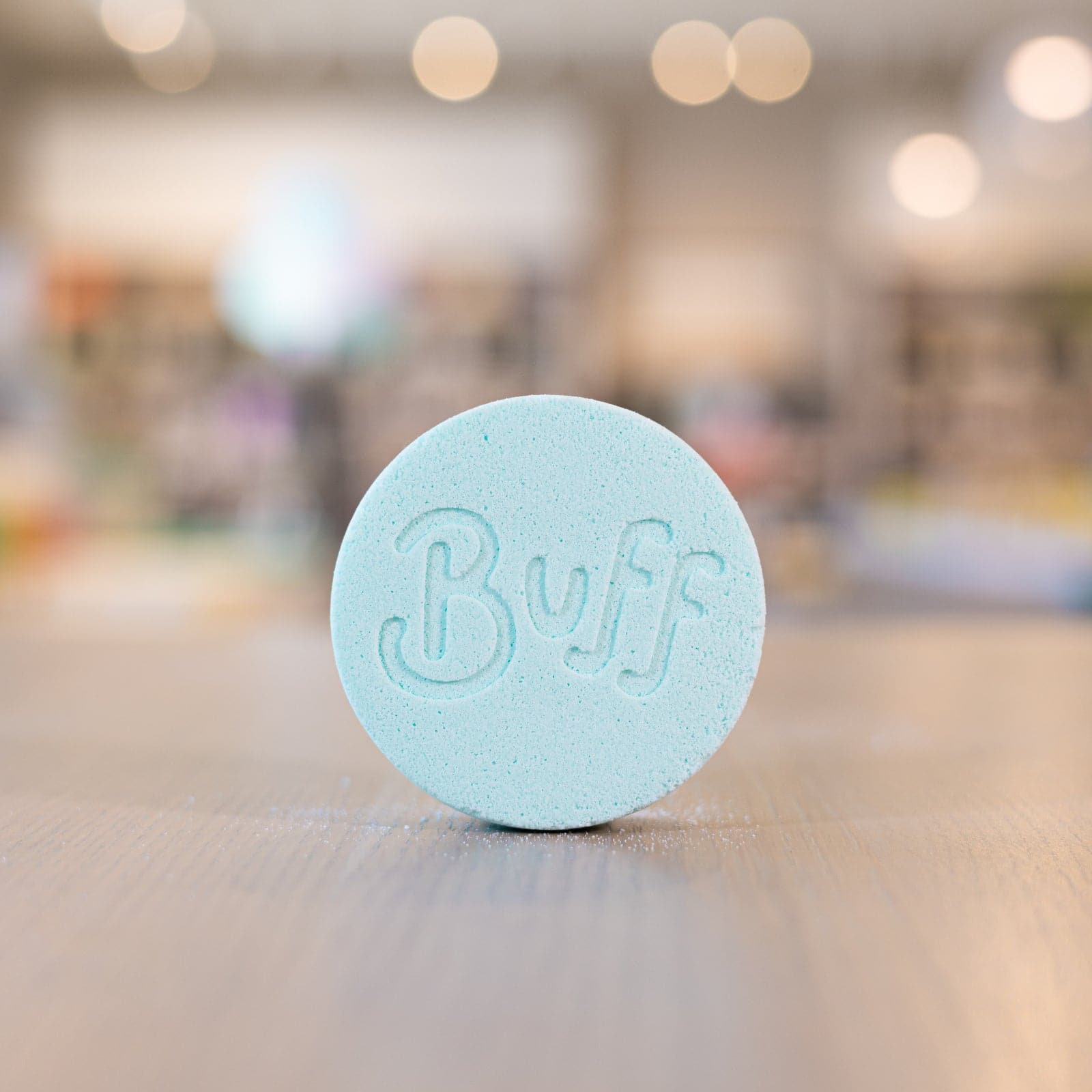 light blue Narcissist Shower Fizzy with "Buff" engraved in it