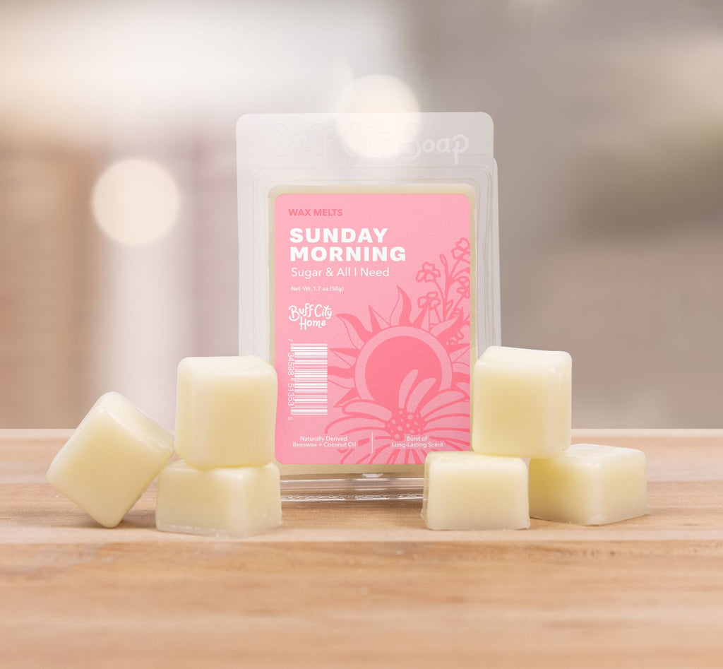 Buff City Soap Sunday Morning Wax Melts staggered in front of container 