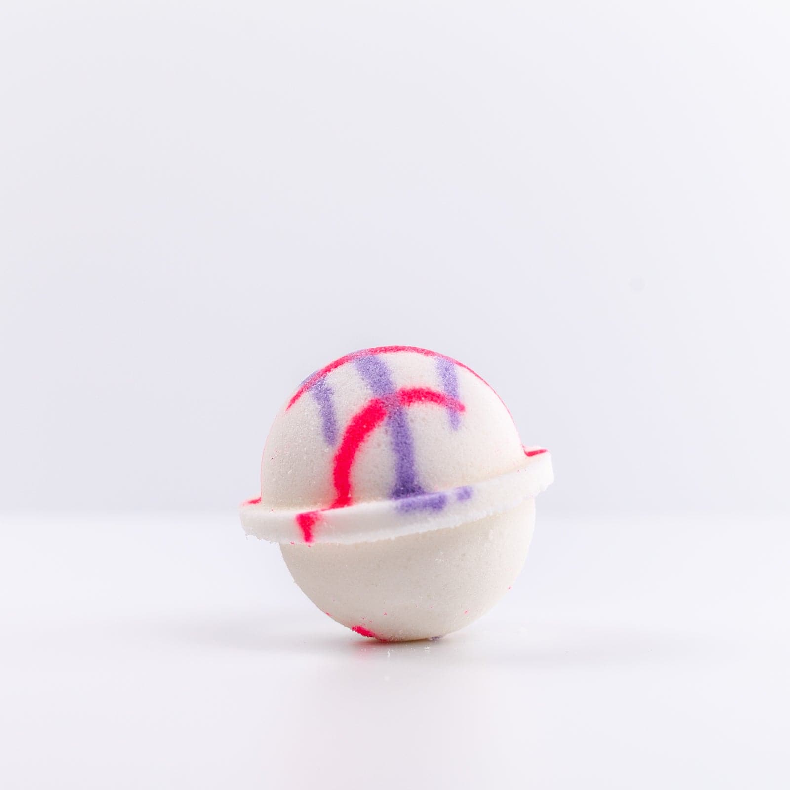 Unicorn Bath Bomb with pink and purple design on the top of it