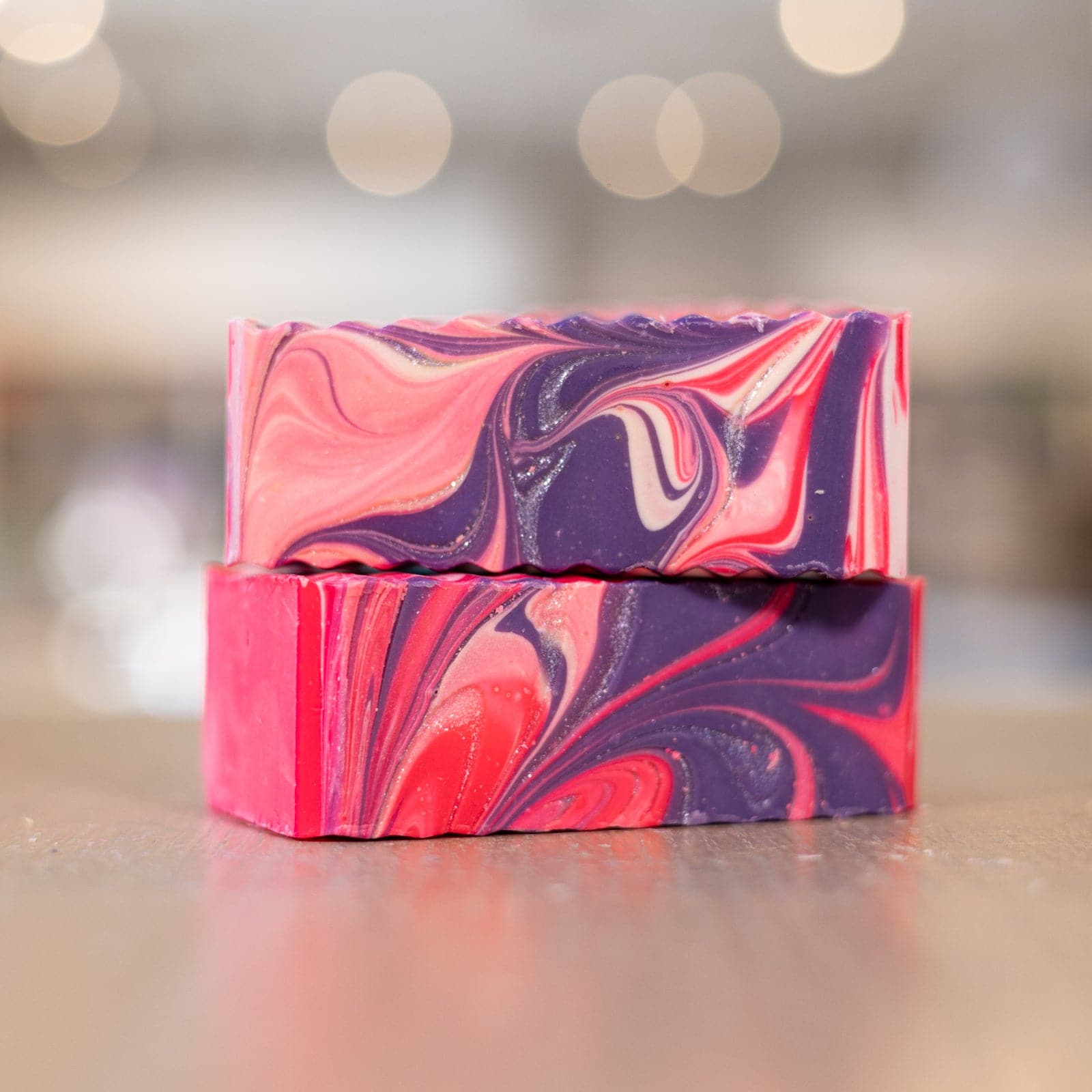 Two Unicorn Soap Bars with pink and purple design stacked on counter